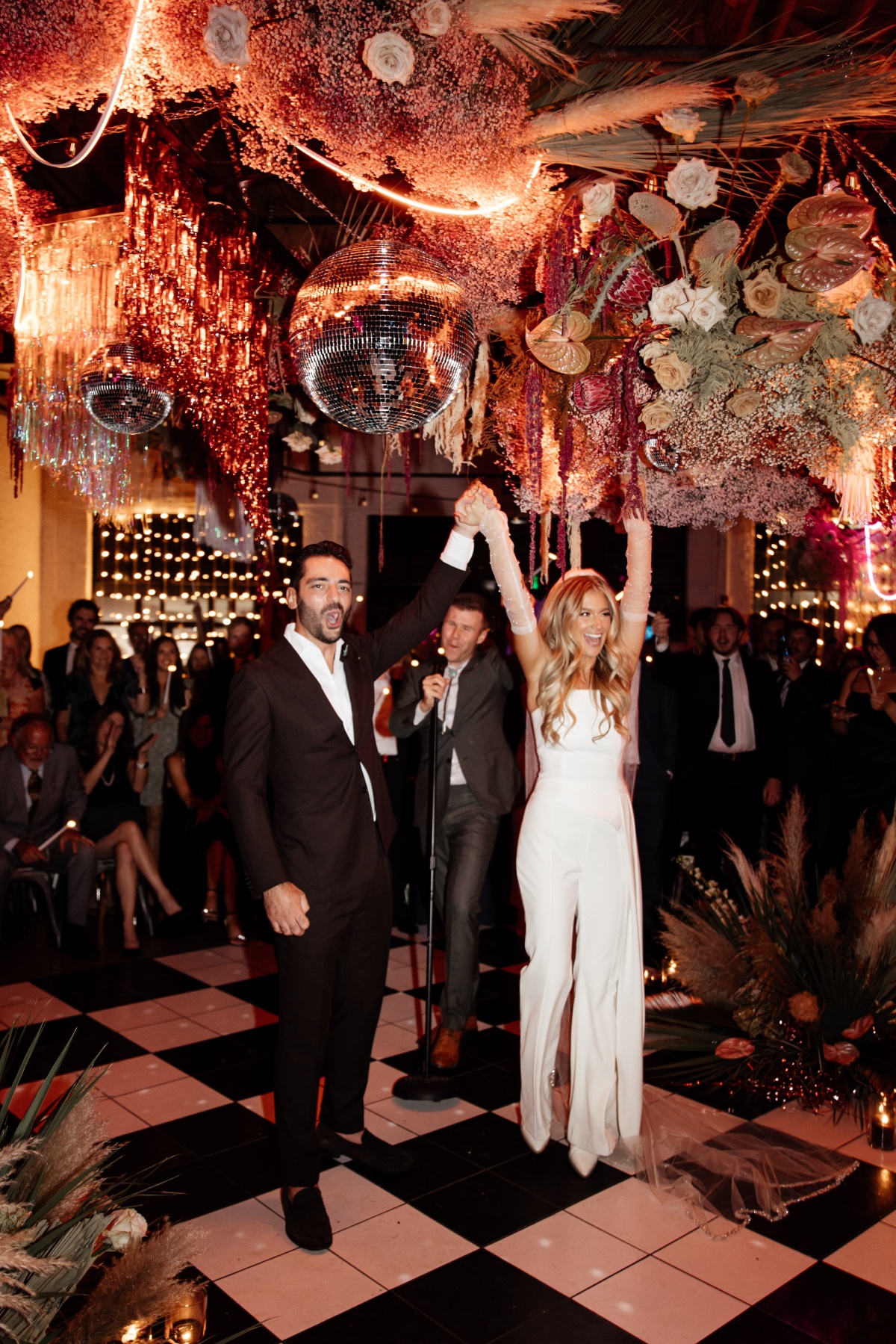 bride wearing a white pantsuit