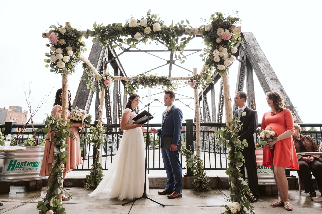 wedding with bridge and denver skyline in the background