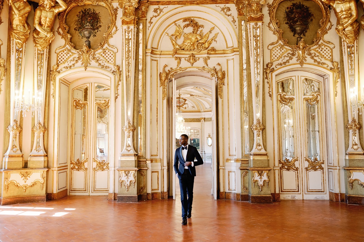 gilded ballroom with groom in tuxedo