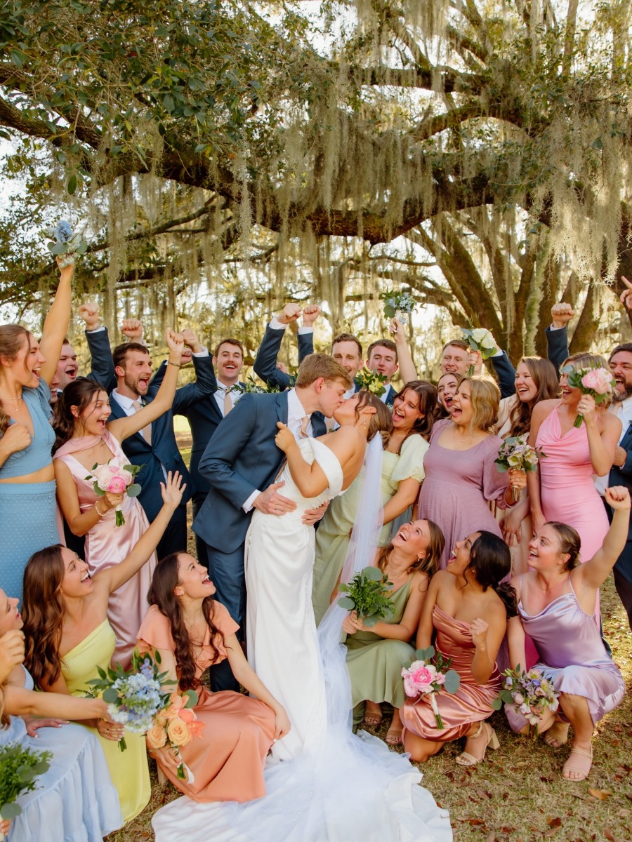 Soft pastel wedding lit by floating lampshades under the Spanish Moss